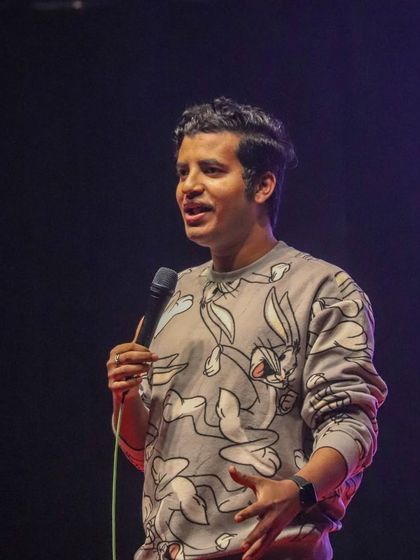 A close-up of Aditya Kullu mid-performance, capturing his engaging and friendly comedic style.