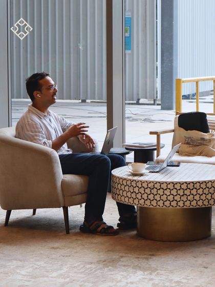 A customer takes a call in one of our comfy armchairs, laptop at the ready. Our space is designed for the flexibility modern work requires.