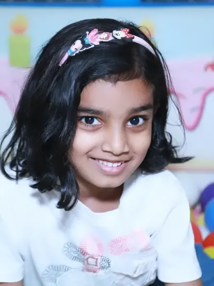 A sweet portrait of a girl in a colorful ball pit during a birthday party. Play areas at events are fantastic for capturing genuine smiles and playful photos.