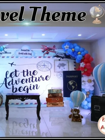 This travel theme setup includes a passport prop and vintage suitcases.