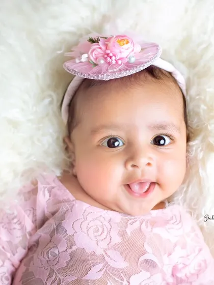 A happy, bright-eyed smile from this little darling in pink. Her personality is already shining through so clearly.
