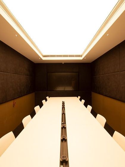 This conference room features a Barrisol stretched ceiling, which I specified to create a perfect, shadow-free plane of light. This solution is ideal for video conferencing and meetings, providing high-quality, glare-free illumination across the entire table.