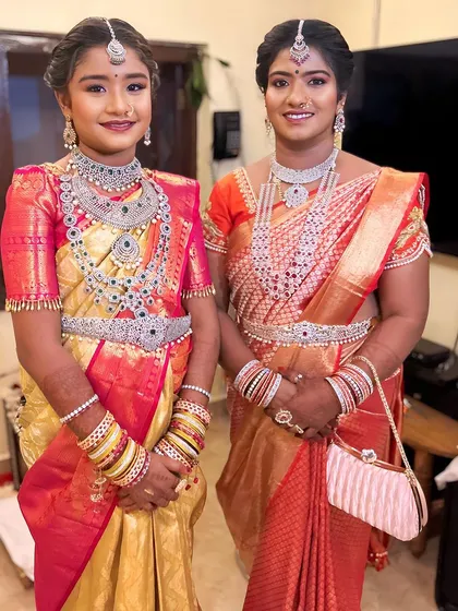 Two ladies elegantly styled in matching American diamond sets. Our collection is perfect for coordinating looks for family members at a wedding.