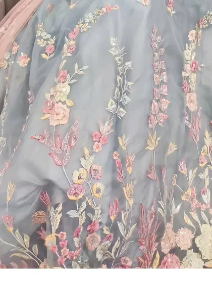A close-up of the beautiful multi-color floral embroidery on one of our popular lehengas. The detail and craftsmanship are what make our collection special.