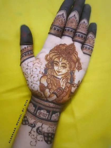 A beautiful portrait of Lord Krishna playing his flute, covering the entire back of the hand.