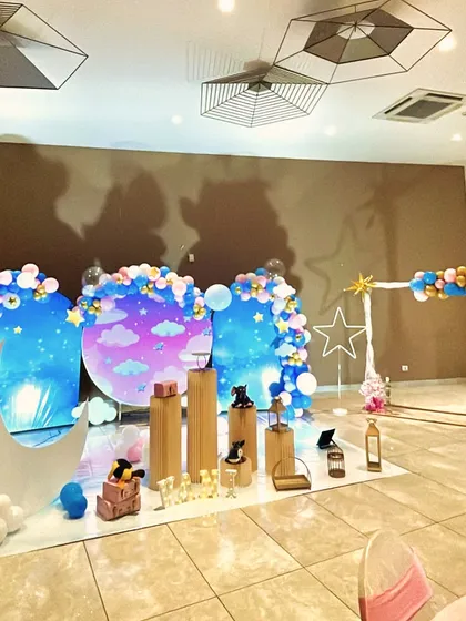 An identical wide shot of the star and moon themed party, showing the full scope of the decorations.