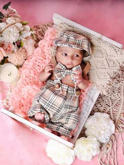 This little guy is awake and looking dapper with his plaid bowtie. This shot shows how we can capture different moods within the same session.