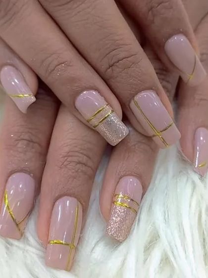 Another look at the modern and chic soft pink nails with geometric gold stripe details.