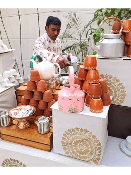 A traditional chai-wallah station, with hand painted kettles and clay kulhads. This charming and rustic setup is perfect for winter high teas and brunches, offering a comforting and authentic beverage experience.