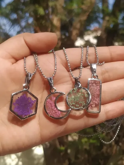 This is a small collection of my floral pendants. I can preserve tiny flowers in various shapes like hexagons, moons, circles, and rectangles, so you can carry a piece of nature with you.