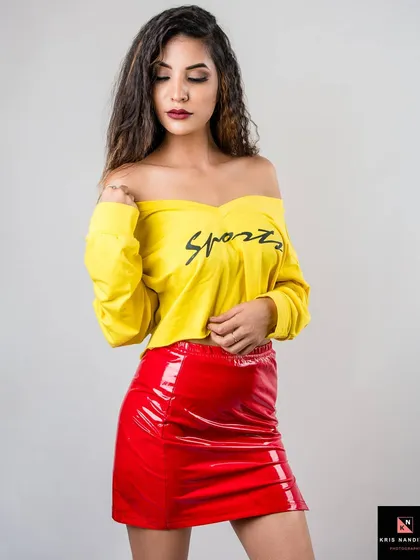 Fashion should be fun. This vibrant, high-contrast look with its bright yellow top and shiny red skirt captures a playful and energetic mood. It’s a great example of a commercial lookbook shot that grabs attention instantly.