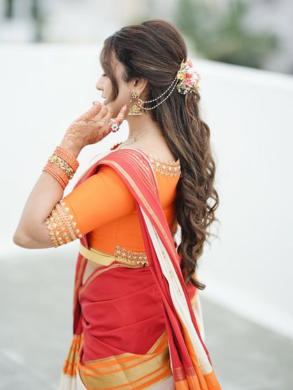 A side view showcasing the elegant hairstyle and the subtle mehendi design, proving that beauty is often in the details.