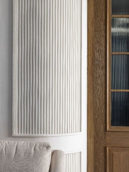 A close-up of the fluted wall panels and reeded glass details in the VRS Office. These classical elements are used with subtlety, adding a layer of texture and quiet luxury that enhances the modern space.