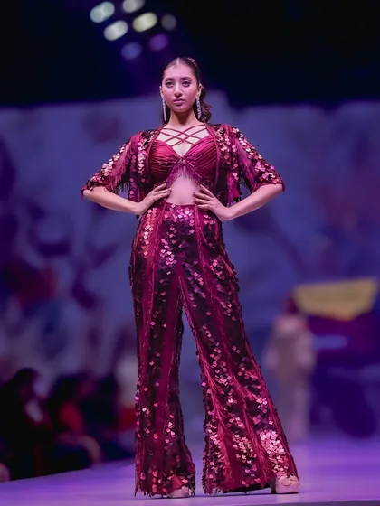 The runway is a place of high energy and bold statements. My goal here was to capture the power and drama of this sequined magenta outfit, using the stage lighting to highlight its texture and the model's confident pose.
