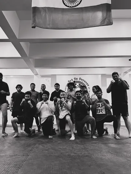 The mats are filled with determination. A black and white shot of our grappling team after a BJJ session.