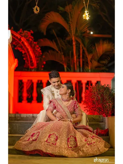 Their eyes spoke the vows before words did. An intimate nighttime portrait of the couple, with the red lighting adding a touch of drama and romance.