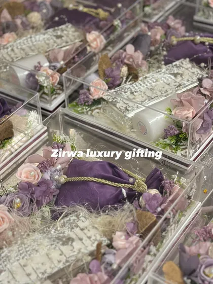 Another look at my lavender-themed wedding favors. These clear acrylic boxes are filled with goodies and decorated with purple flowers and pouches.