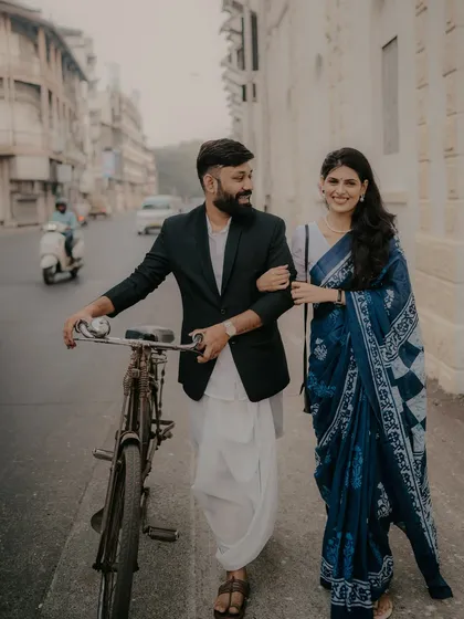 A pre-wedding shoot with a vintage touch on the streets of Mumbai. Using props like this classic bicycle helps tell a unique story. It’s about creating a fun, nostalgic scene that reflects the couple's personality against an urban backdrop.