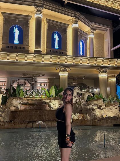 A playful pose in the black dress. This adds a bit of fun and personality to the sophisticated look.