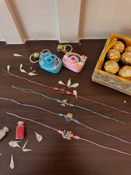 For the little ones, I've created these fun and playful rakhis. Featuring popular cartoon characters and paired with cute camera-shaped keychains, they are sure to bring a smile to any child's face.