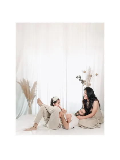 A playful moment on the floor during a family studio session. These relaxed, candid interactions often make for the most cherished photographs.