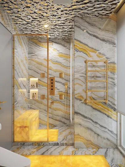 This bathroom design features a glowing honey onyx feature wall, illuminated with LED panels to create a warm, ambient glow. The gold fixtures and unique textured ceiling add to the luxurious feel.