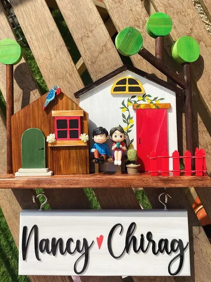 One of my most-loved designs, this nameplate features a cozy home scene with a couple, complete with key hooks for added function. It’s a charming and practical piece to welcome you home every day.