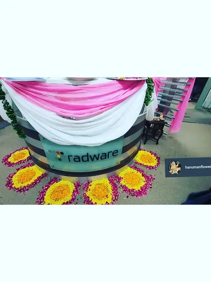 Here is the decorated circular reception desk at Radware, draped in fabric and surrounded by a petal rangoli design. It’s the first thing visitors see, and we made sure it was festive and welcoming.