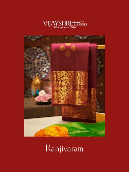A beautiful maroon Kanjivaram with gold zari buttas and a heavy border.