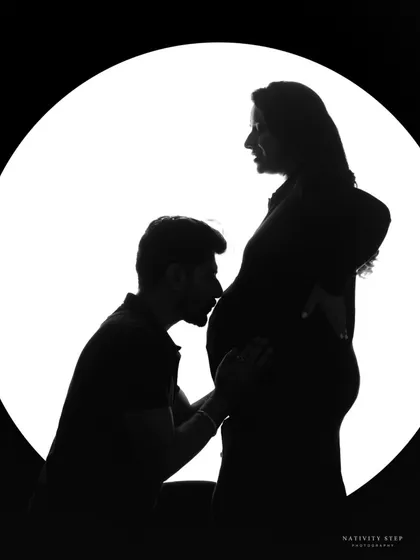 A tender silhouette of the husband-to-be kissing the baby bump. This is a powerful and emotional image that speaks volumes without words.