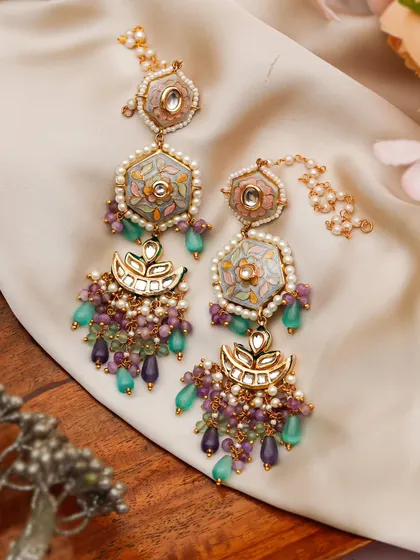 Here, I used a mix of textures, including wood and soft fabric, to create a rich, layered look for these pastel-colored Meenakari earrings. The composition highlights the delicate beadwork and unique hexagonal shape.