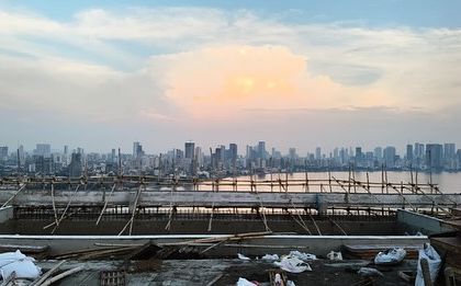 A view from the top of the DLH Signature tower under construction in Mumbai. This image captures the breathtaking panoramic view where the city's dense urban fabric meets the Arabian Sea, a key consideration in our design.