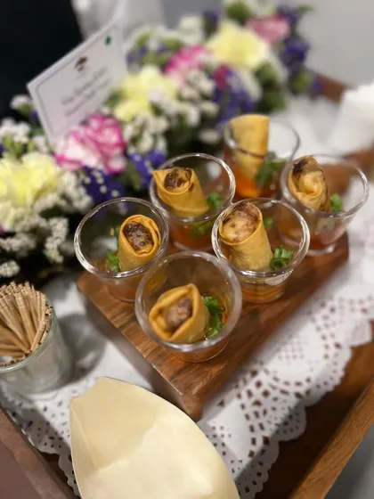 Our mini spring rolls are always a hit. Here they are served in shot glasses with sweet chili sauce, a creative and clean way for guests to enjoy this classic appetizer.