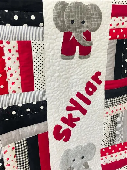 Personalized baby quilts are one of our favorite projects. For this piece, we did the piecing, appliqué of the elephants and the name 'Skylar', and finished it with soft, durable longarm quilting.