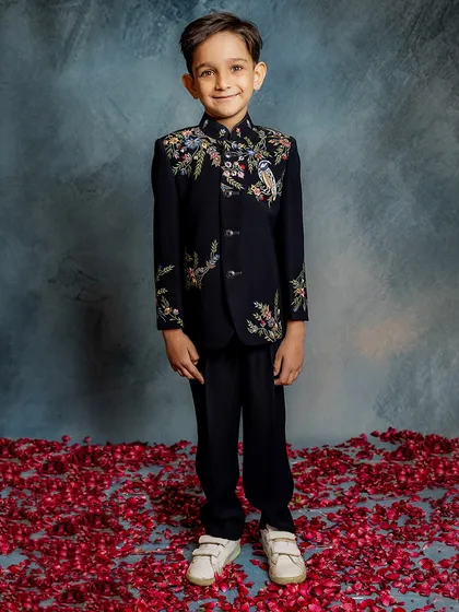 This is where modern style meets timeless craftsmanship. Our bestselling Indo-western jacket features intricate floral and bird embroidery on a classic black base, perfect for any celebration where your boy deserves to be the star.