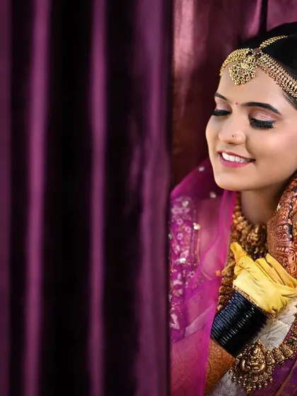 A beautiful candid of Disha adjusting her earring, her makeup looking soft and pretty under the lights.