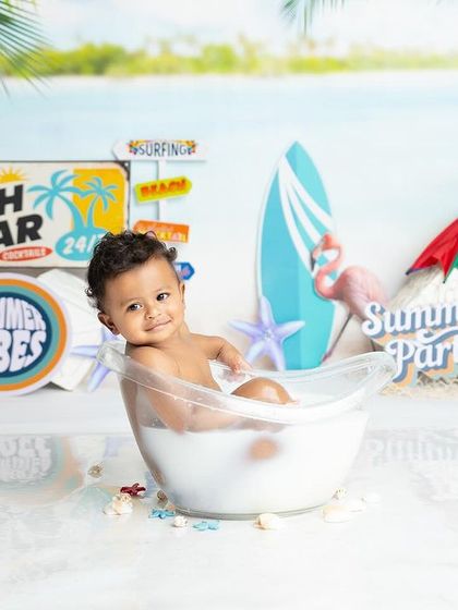 Soaking up the summer vibes in this beach-themed tub session. Complete with a surfboard, tropical signs, and a mini flamingo, it's a perfect summer party for one.
