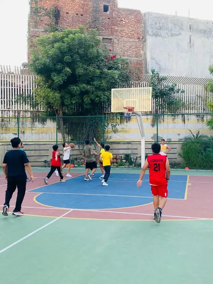 A player attempts a jump shot during an evening session.