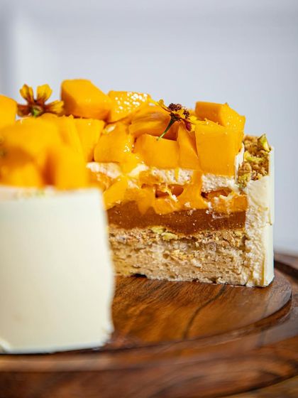 A close-up of the layers in our mango cake, showing the light sponge, mango compote, and fresh fruit. This is what makes our mango cake supreme.