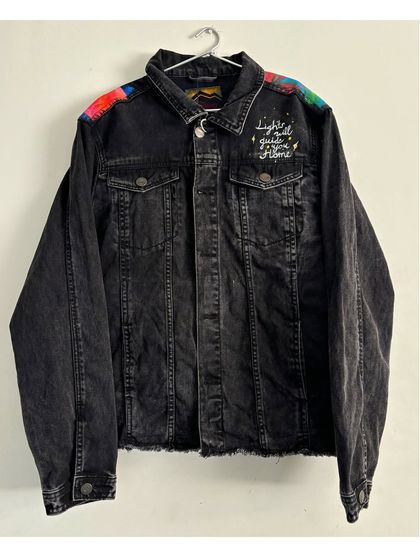 The front of the black denim jacket customized for a Coldplay concert in Hong Kong. While the main artwork is on the back, I added small, colorful details on the shoulders and a handwritten lyric, "lights will guide you home," on the chest.