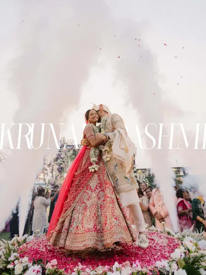 A moment of pure cinematic magic for Krunal and Rashmi. As they embraced, surrounded by a cloud of celebratory smoke and flowers, it felt like the world stood still just for them. This is the kind of grand, unforgettable memory I strive to create.