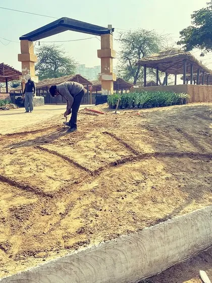 Every big project starts with a simple line in the dirt. This is me marking out the landscape design for a large flower bed at the Surajkund Mela. This initial groundwork is crucial for bringing the final vision to life.