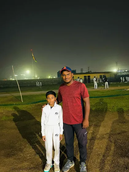 Aayush with his coach after his century in a day-night match.