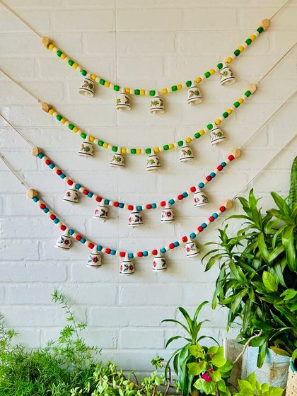 A beautiful display of our 'Khanak' beaded bell buntings. Available in multiple color options, these are perfect for decorating doorways, temples, or any cozy corner of your home with a blend of color and sound.