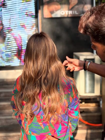 Our stylist adding the finishing touches to this beautiful caramel honey hair color.