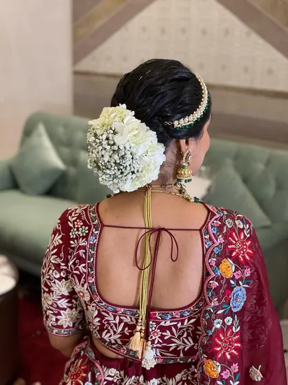 A timeless floral bun created with a myriad of hydrangeas and gypso. The all-white flowers create a look of pure elegance and sophistication.