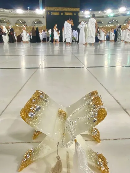 There is no greater honor than seeing my work in the holiest of places. This is my white and gold resin Quran holder, complete with a crystal tasbeeh, resting in the sacred space of the Kaaba in Makkah.