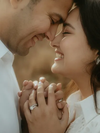 An intimate close-up of a couple, their faces close together, sharing a genuine, joyful smile. This shot focuses on the raw emotion and connection, capturing the essence of a candid couple portrait.