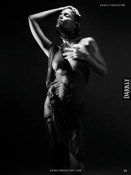 This frame from 'Elegy in Motion' captures a moment of release, with the model's body arched towards the light.