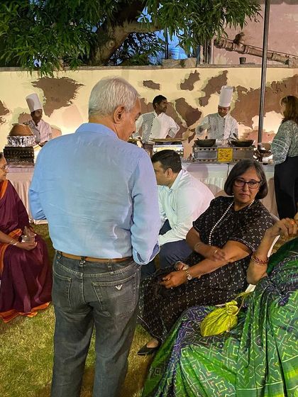 Guests enjoying the food and atmosphere at the celebratory dinner.